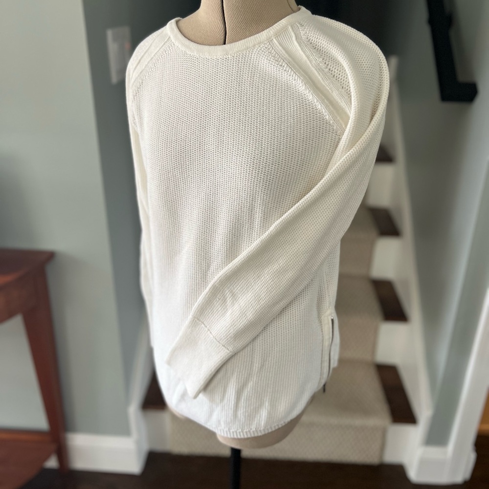A white long sleeve knit top